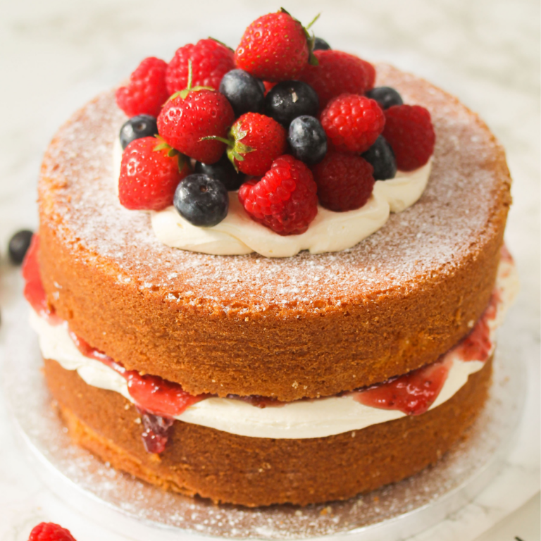 Classic Victoria Sandwich with buttercream and fresh berries.