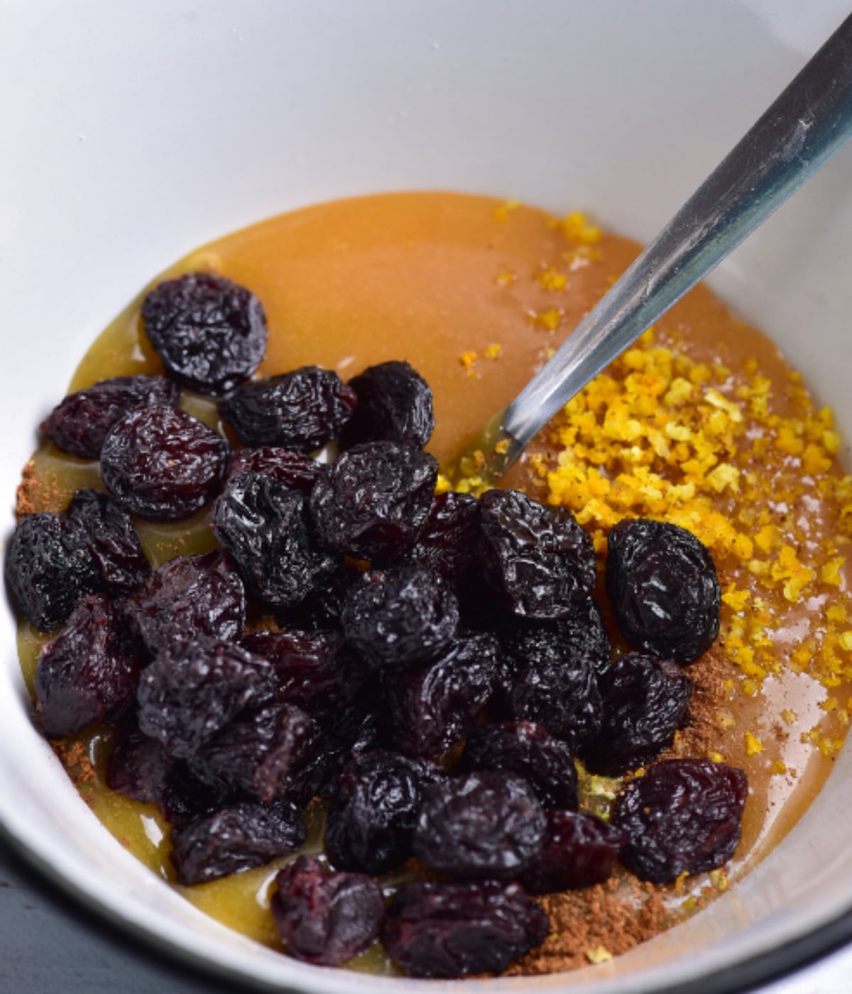 Raisins, lemon zest, and fruit curd in a bowl.