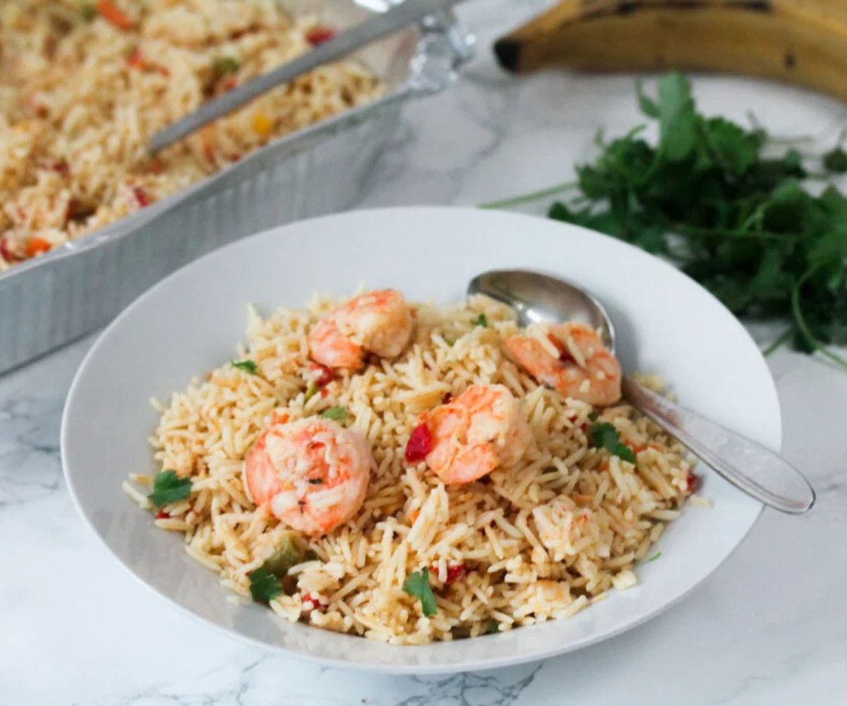 Coconut Fried Rice with prawns and vegetables on a white plate.