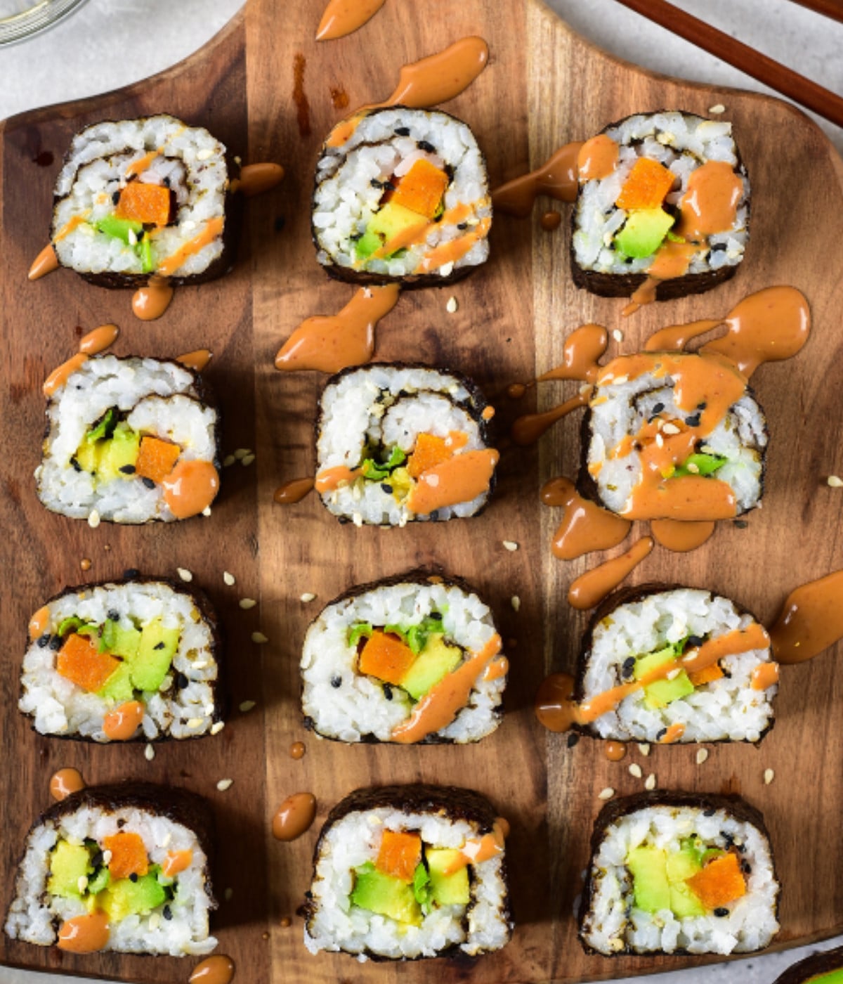 Rolled sushi white rice and sesame seeds, sweet potato, avocado and spicy mayo.
