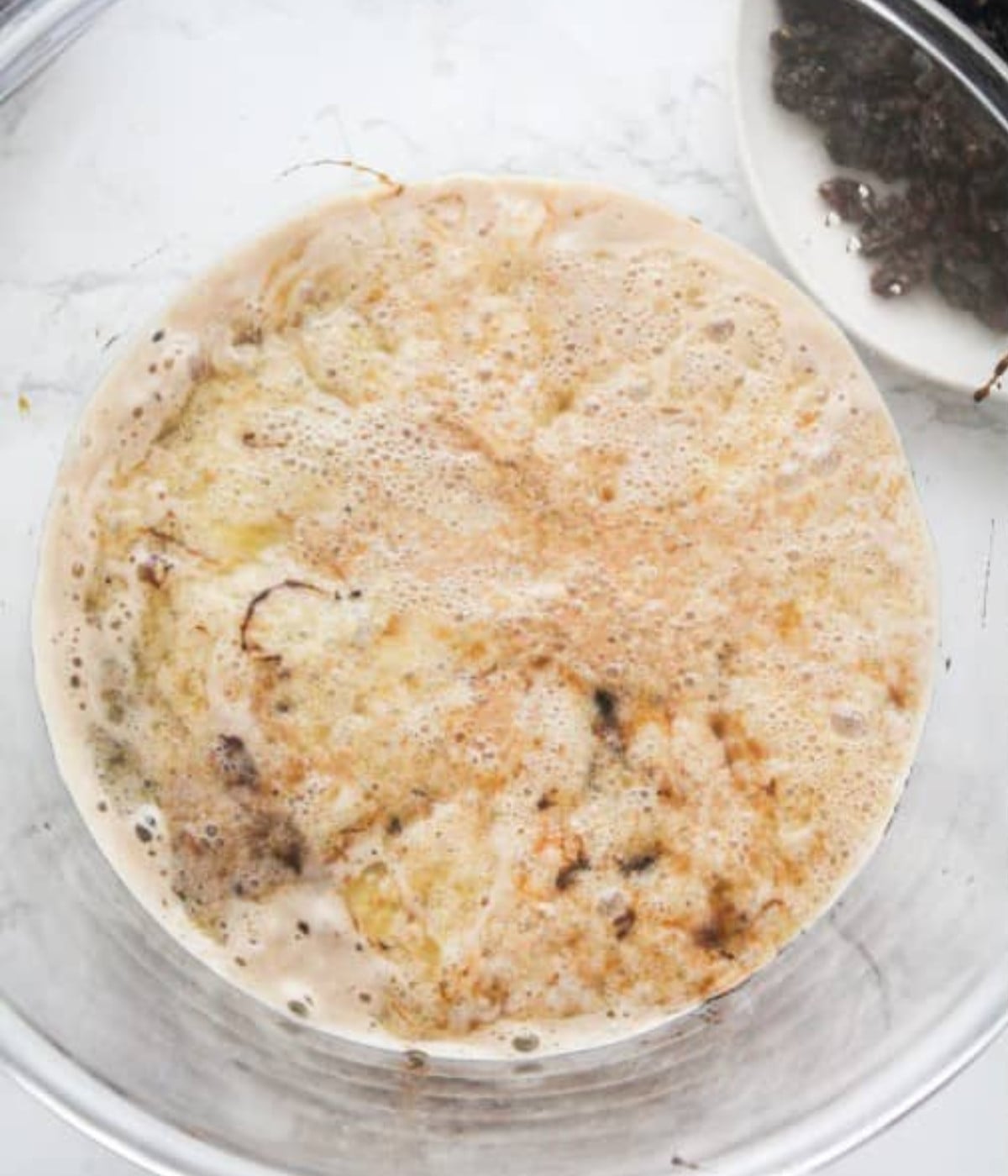 Honey, Guinness, molasses, browning, melted butter, brown sugar and vanilla essence in a glass bowl.