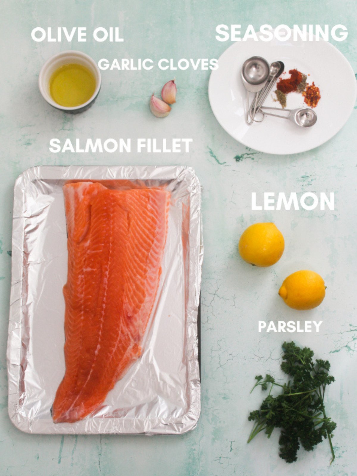 Olive oil, garlic, seasoning, lemon, parsley and salmon fillet.
