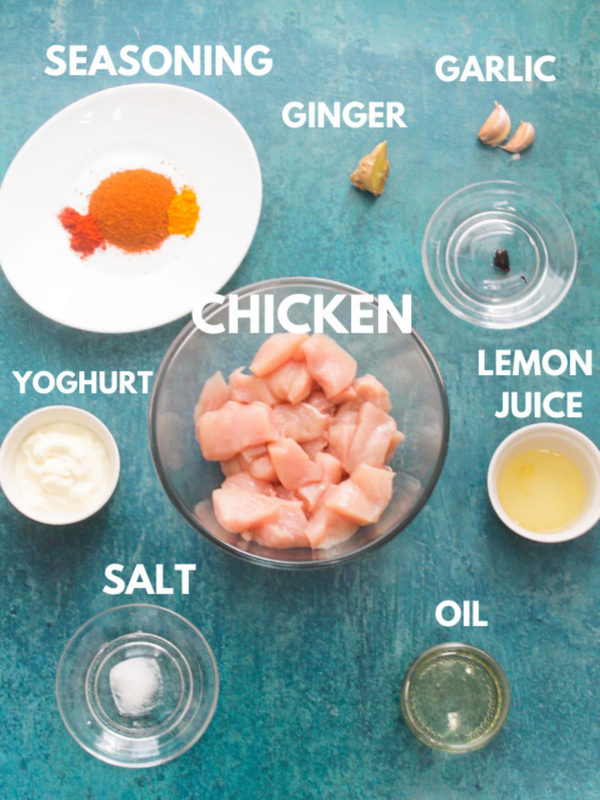 Uncooked chicken, seasoning, ginger, lemon, garlic and yogurt.