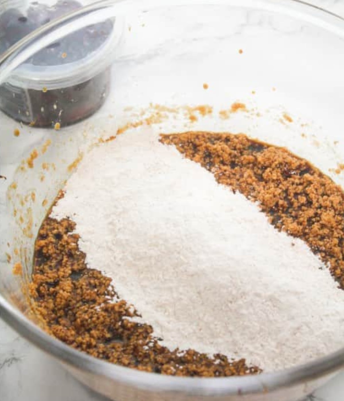 Whisked honey, Guinness, molasses, browning, melted butter, brown sugar and flour in a glass bowl.