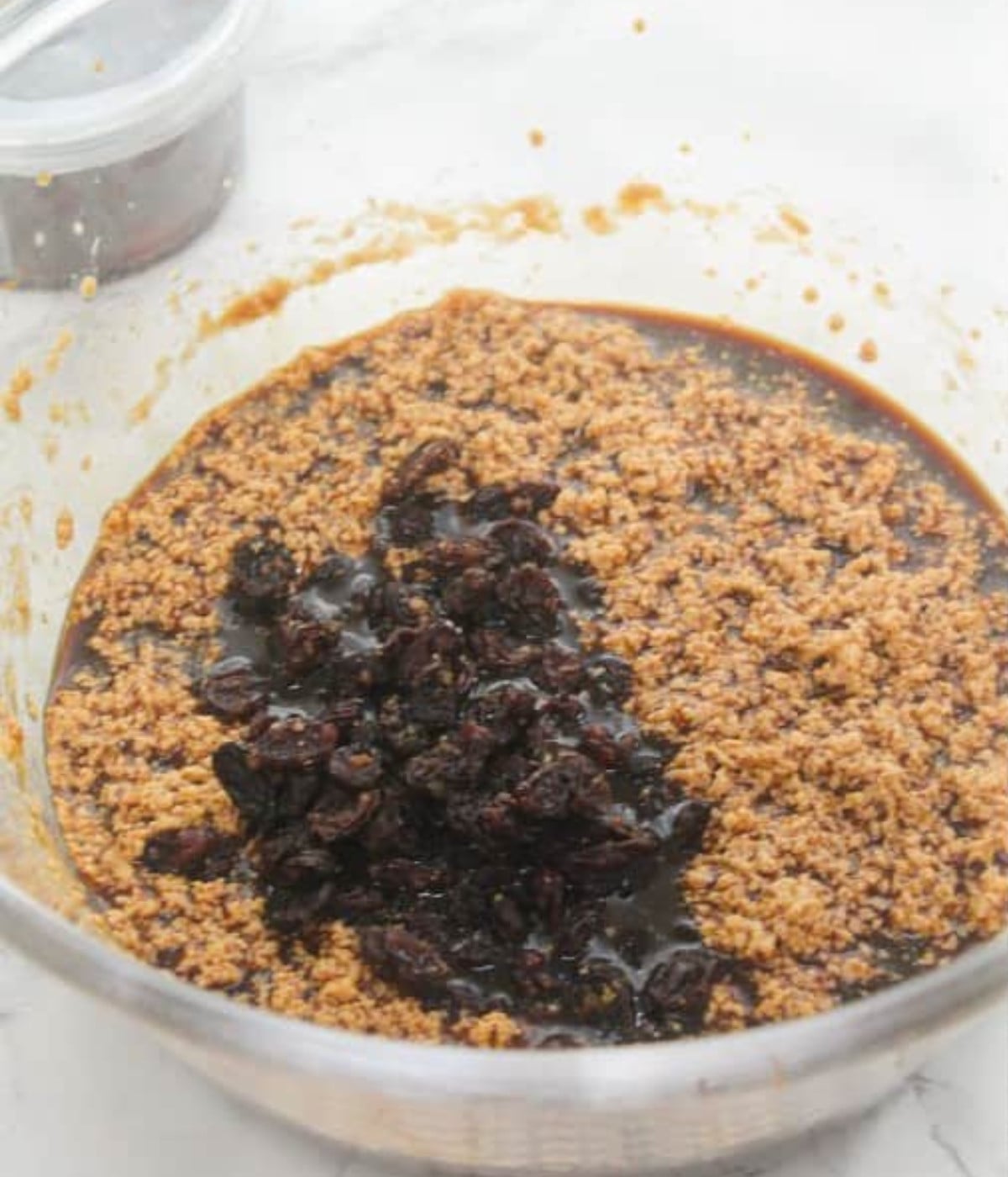 Whisked honey, Guinness, molasses, browning, melted butter, brown sugar and rasins in a glass bowl.