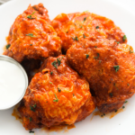 hot chicken thighs served with sour cream