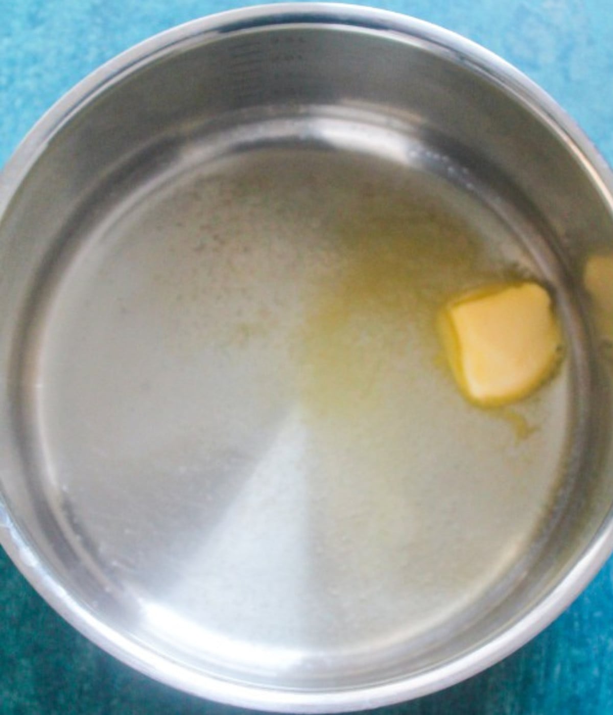 Butter melted in a silver pot.