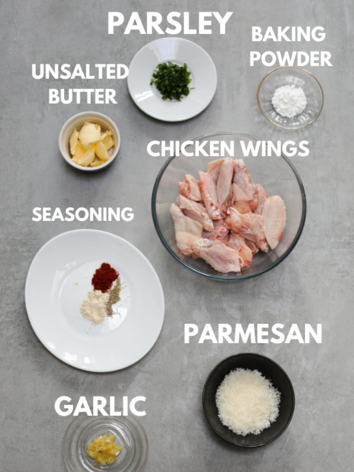 Parsley, uncooked wings, garlic, parmesan, butter, seasoning and baking powder.