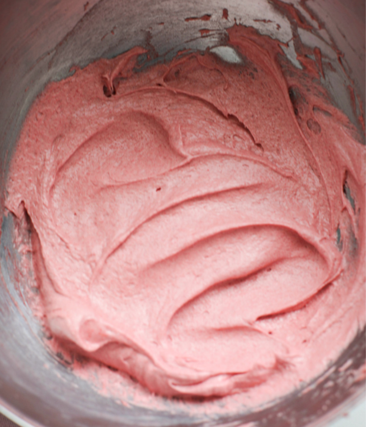 Whpped butter, cream cheese, freeze dried strawberries and icing sugar in a silver bowl.