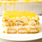 A slice of lemon tiramisu on a white plate.