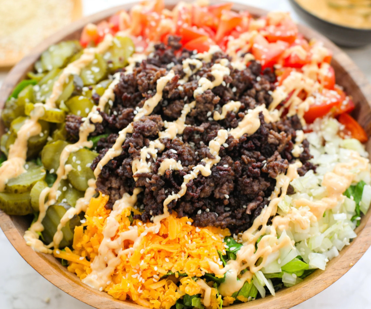 Bigmac salad topped with big mac sauce.
