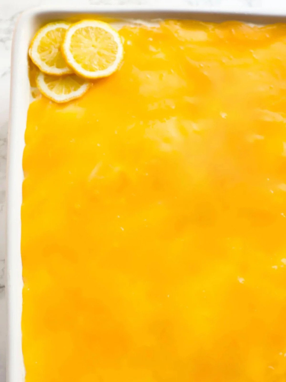 Lemon tiramisu dessert in a white rectangle dish.