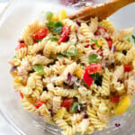 Tuna fusilli in a glass bowl with a wooden fork.