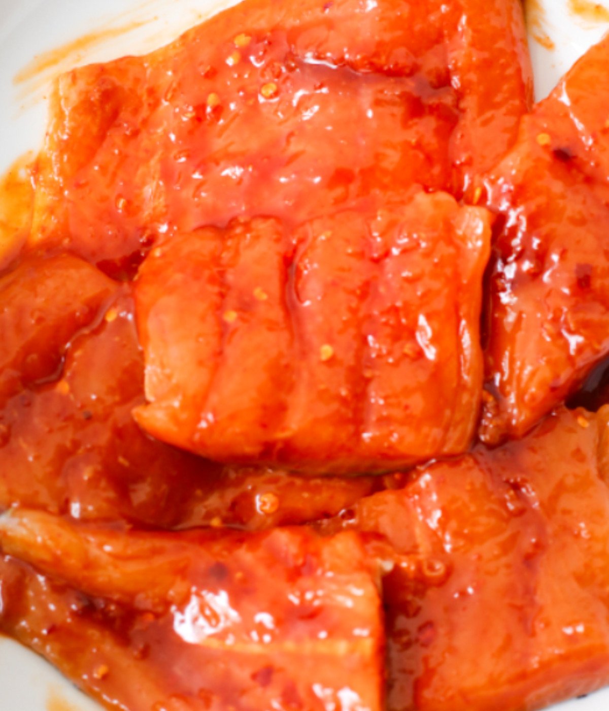Uncooked salmon pieces marinated with spicy marinade.