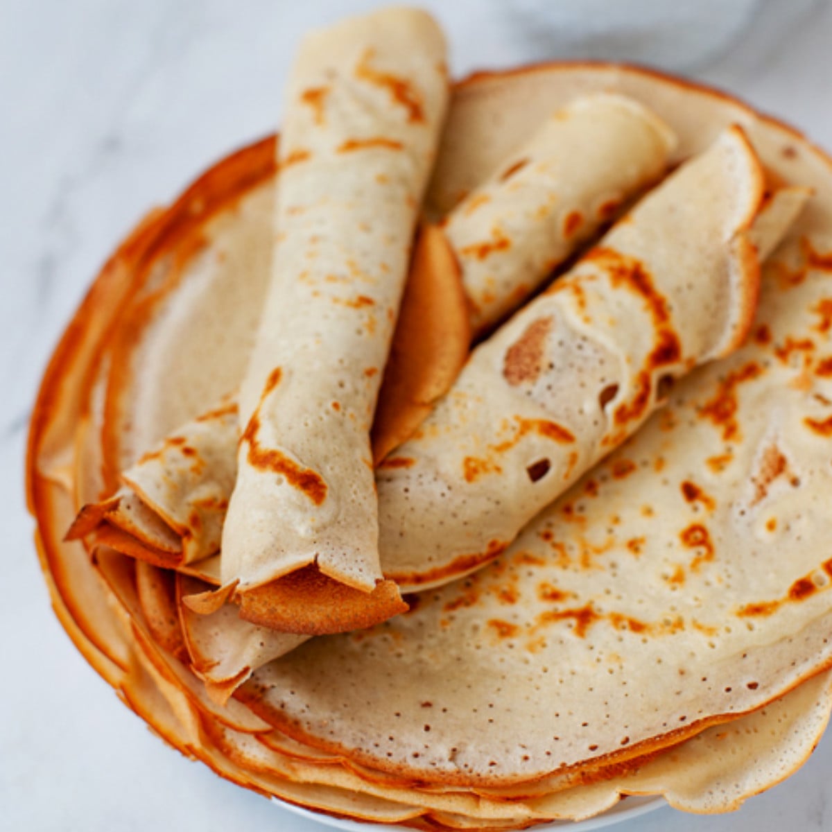 African pancakes rolled on a plate.