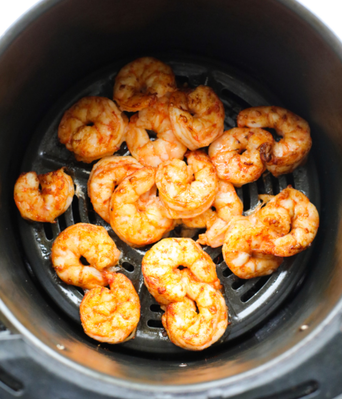 Cooked shrimp in an air fryer.