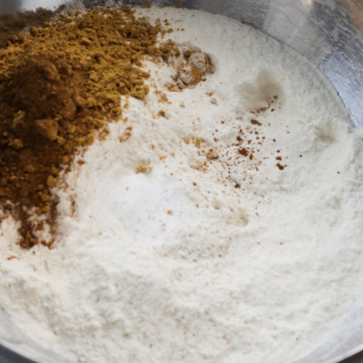 Flour, cinnamon and nutmeg in a silver bowl.