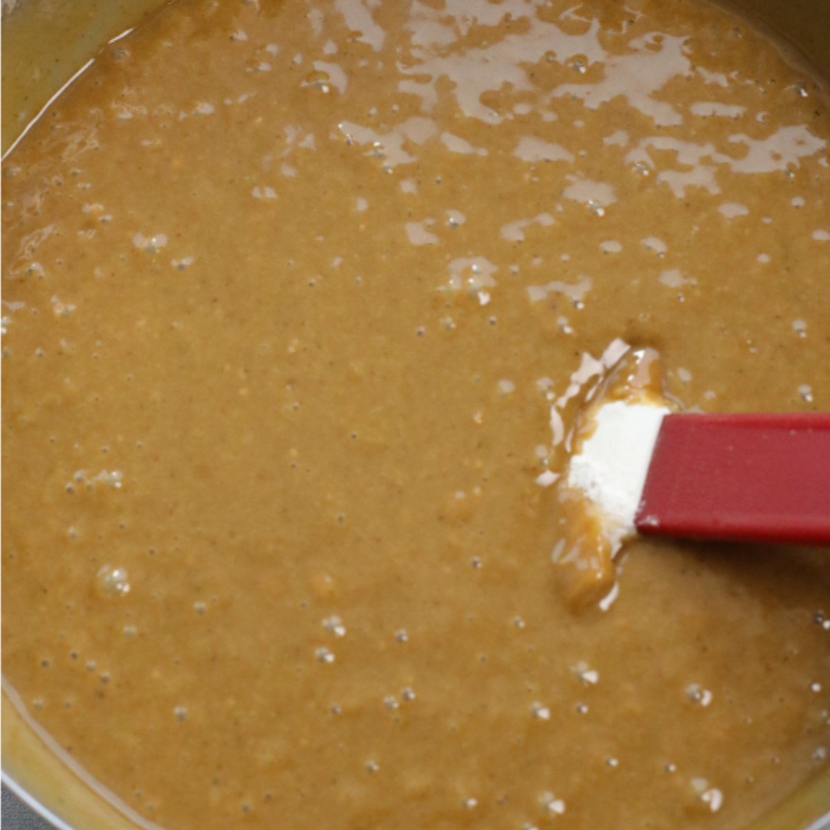 Flour mix, melted butter, brown sugar, black treacle, golden syrup and milk stirred in a bowl.