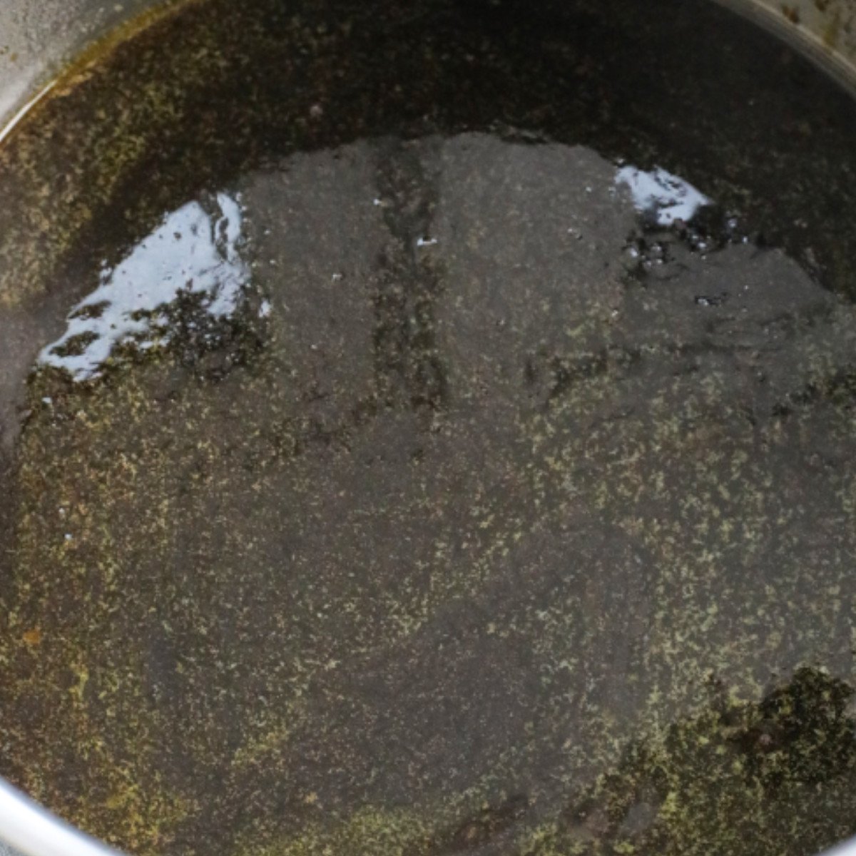 Melted butter, brown sugar, black treacle and golden syrup stirred in a pot.