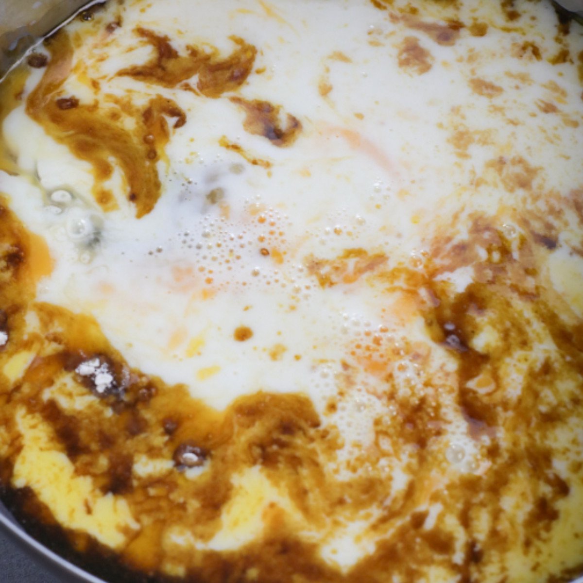 Melted butter, brown sugar, black treacle, golden syrup and milk stirred in a pot.