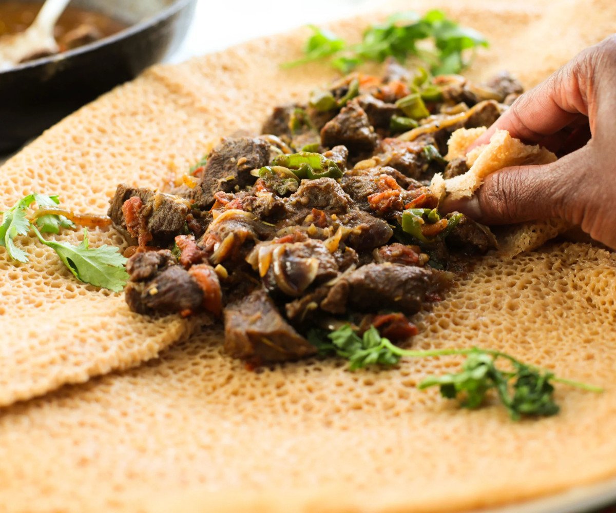 Cooked Ethiopian beef on injera.