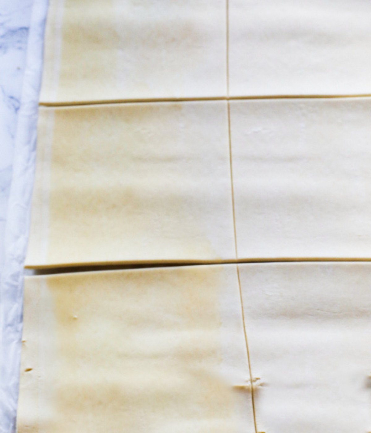 Puff pastry sheet chopped into equal sized squares.