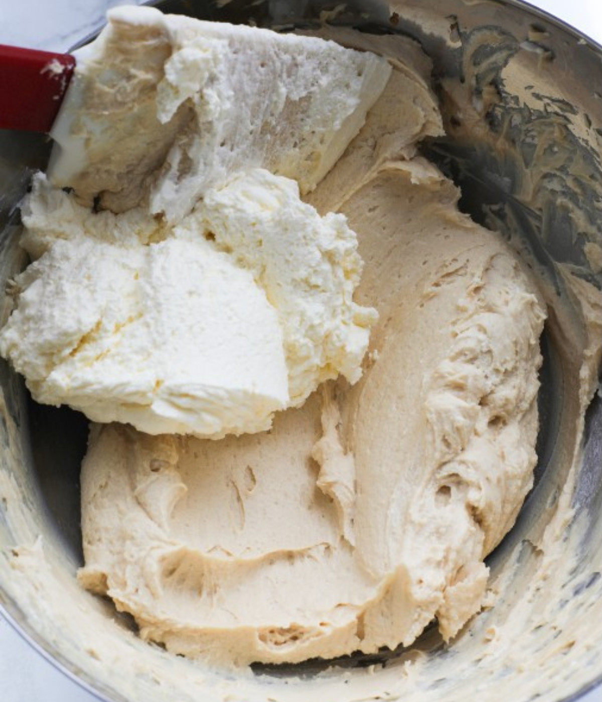 Cream cheese lotus biscoff mixed in a silver bowl.