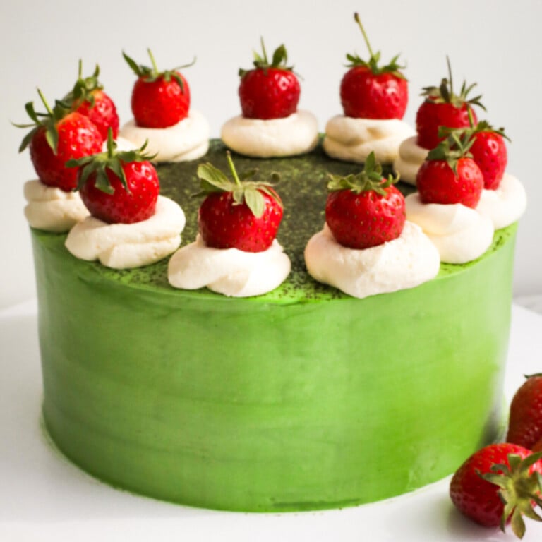 Matcha cake with strawberries and cream.