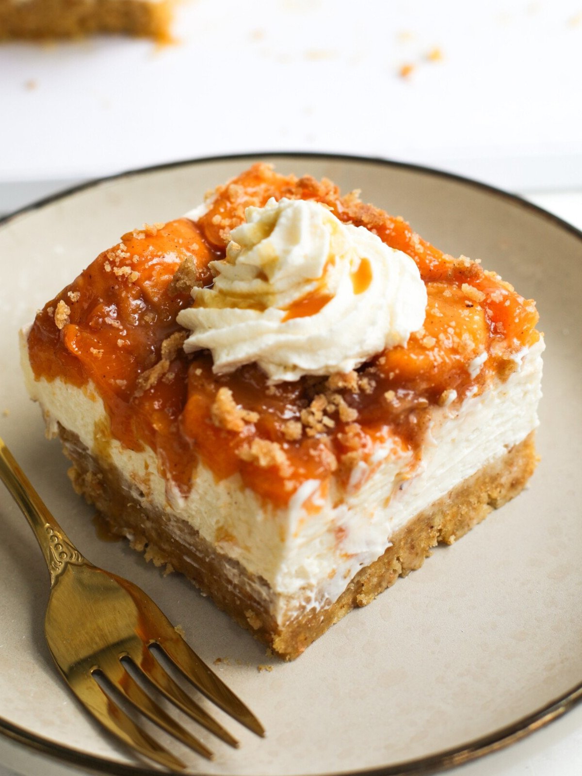 Caramelized no-bake peaches cheesecake dessert on a plate.