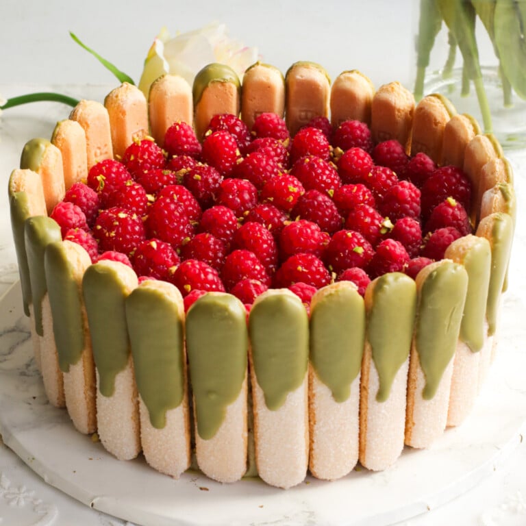 Tiramisu with pistachios dessert topped with raspberries.