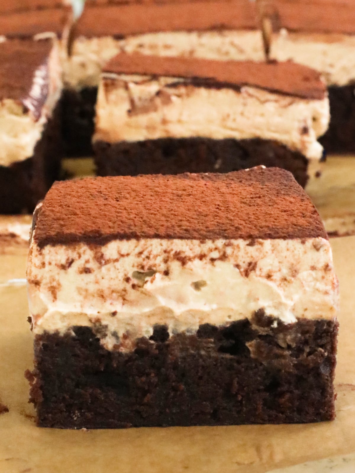 Chocolate coffee brownies with mascarpone and cocoa powder on top.
