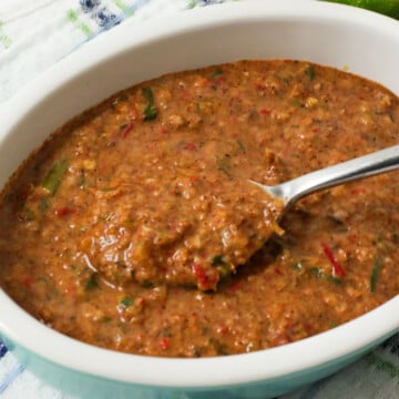 Jerk marinades are in a bowl with a spoon.