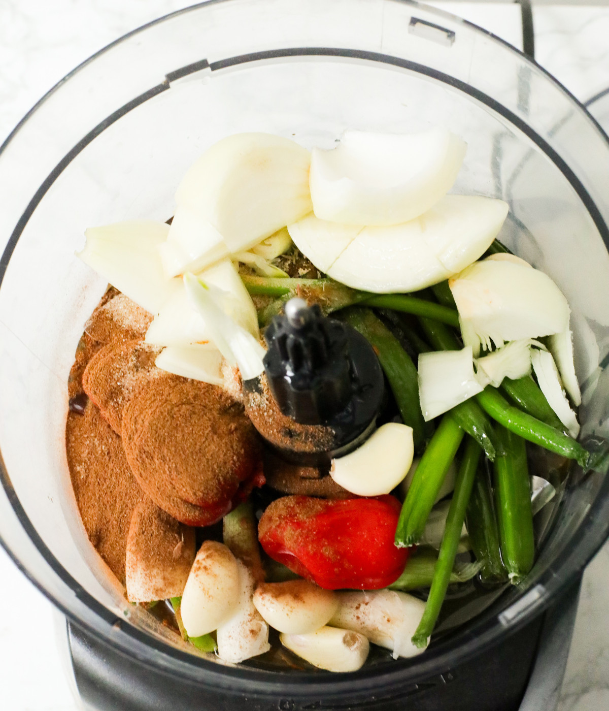 Onions, spring onions, scotch bonnets, garlic and warm spices in a food proccessor.