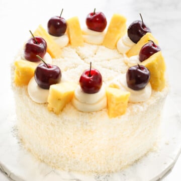 Pinaa colada cake on a marble cake board.