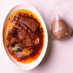 Amala, nigerian stew, gbegiri and ewdu in a bowl.