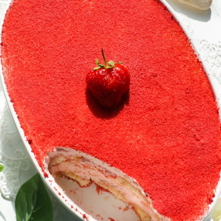 No-egg tiramisu with strawberries in a white oval dish.