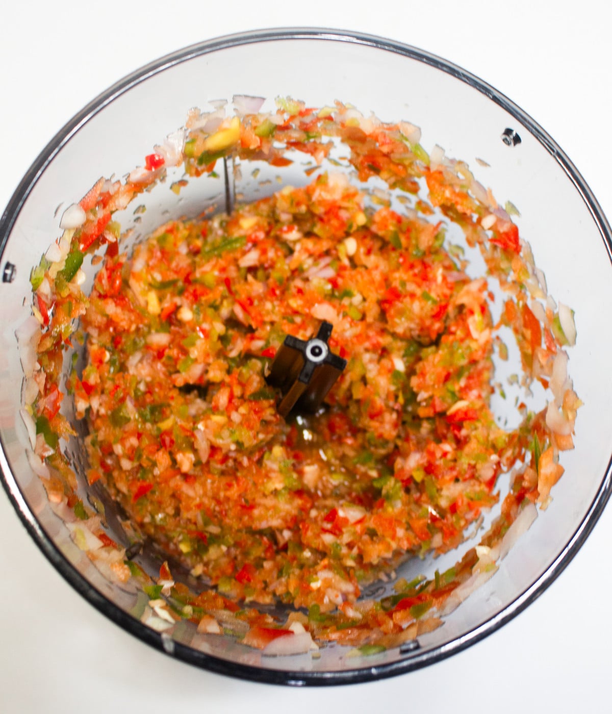 Red bell peppers, green peppers and onions blended in a blender.