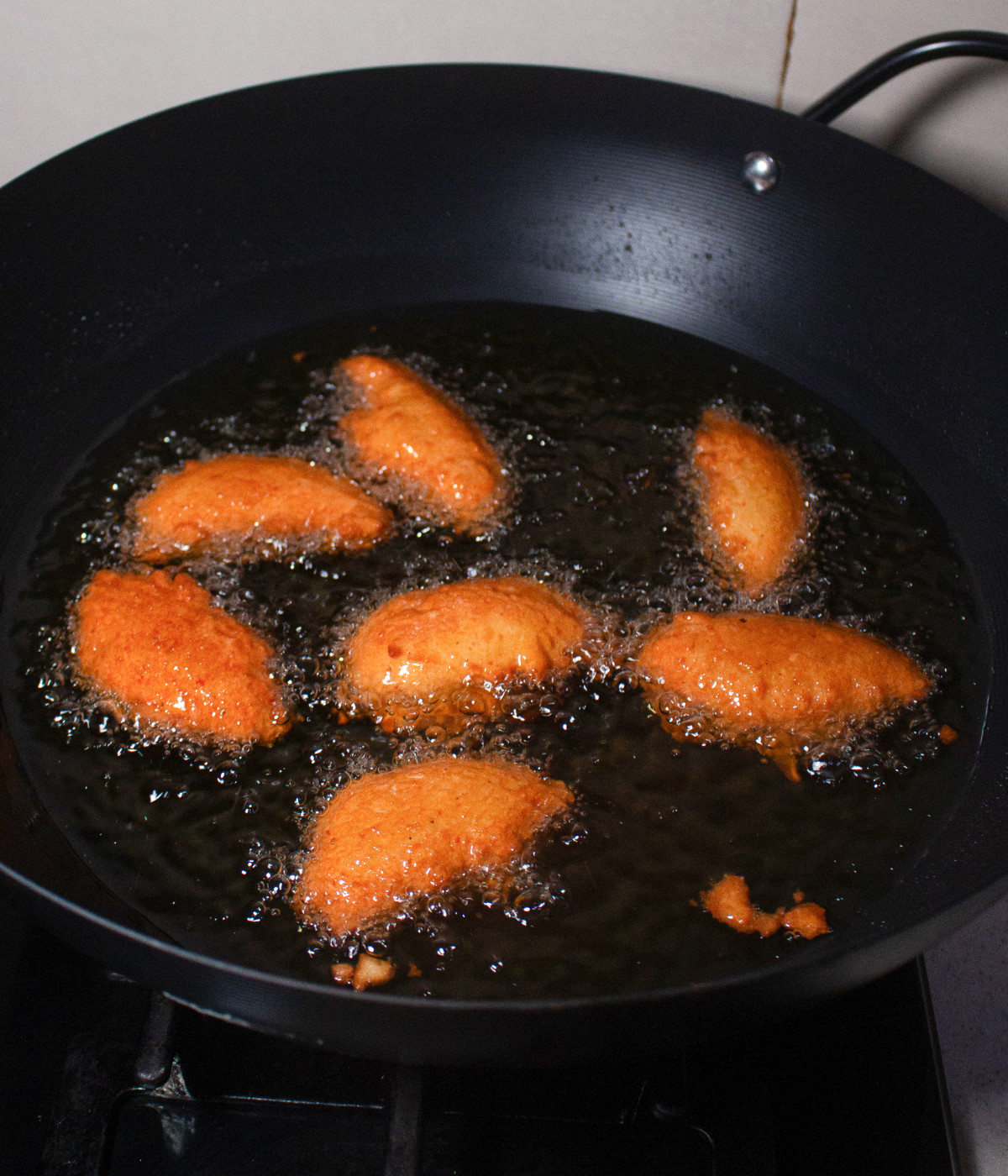 Bean fritters cooking in hot oil.