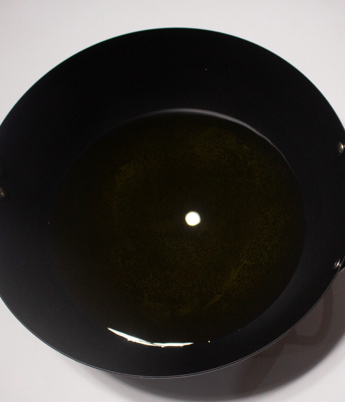 Hot oil in a black pan.