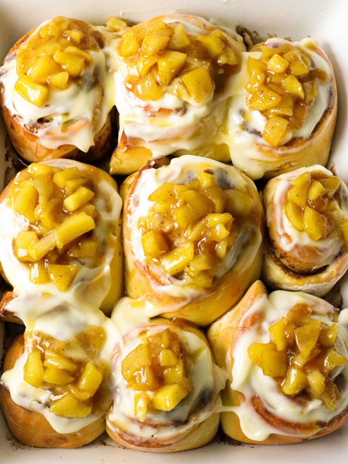 Apple cinnamon rolls in a white rectangle dish.