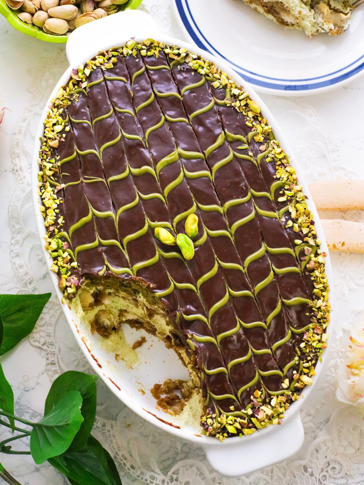Dubais chocolate and pistachio tiramisu served in a white oval dish.