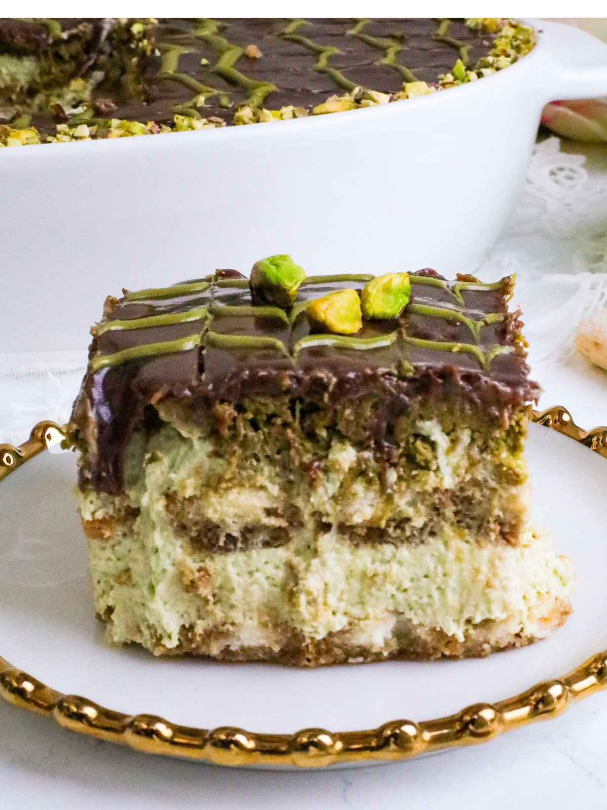 Dubais chocolate kataifi and pistachio tiramisu in a white oval dish.