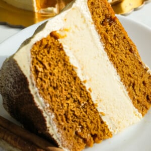 Pumpkin Cake with cheese cake in the center on a plate.
