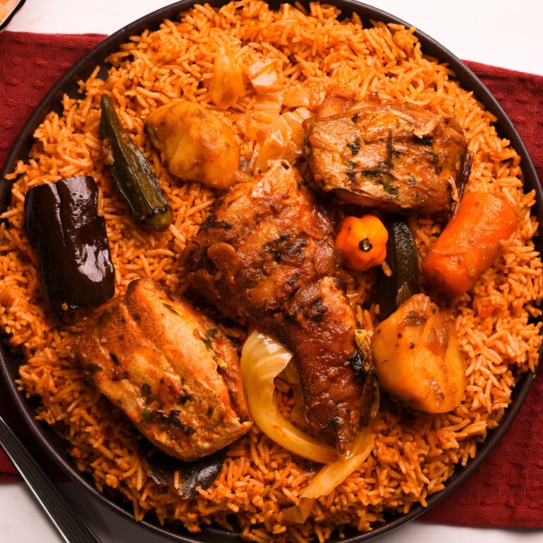 Senegalese jollof in a black plate on a red cloth.
