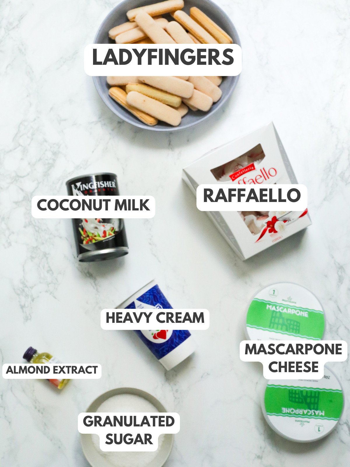 Ladyfingers, coconut milk, Raffaello, heavy cream, mascarpone, granulated sugar and almond extract.