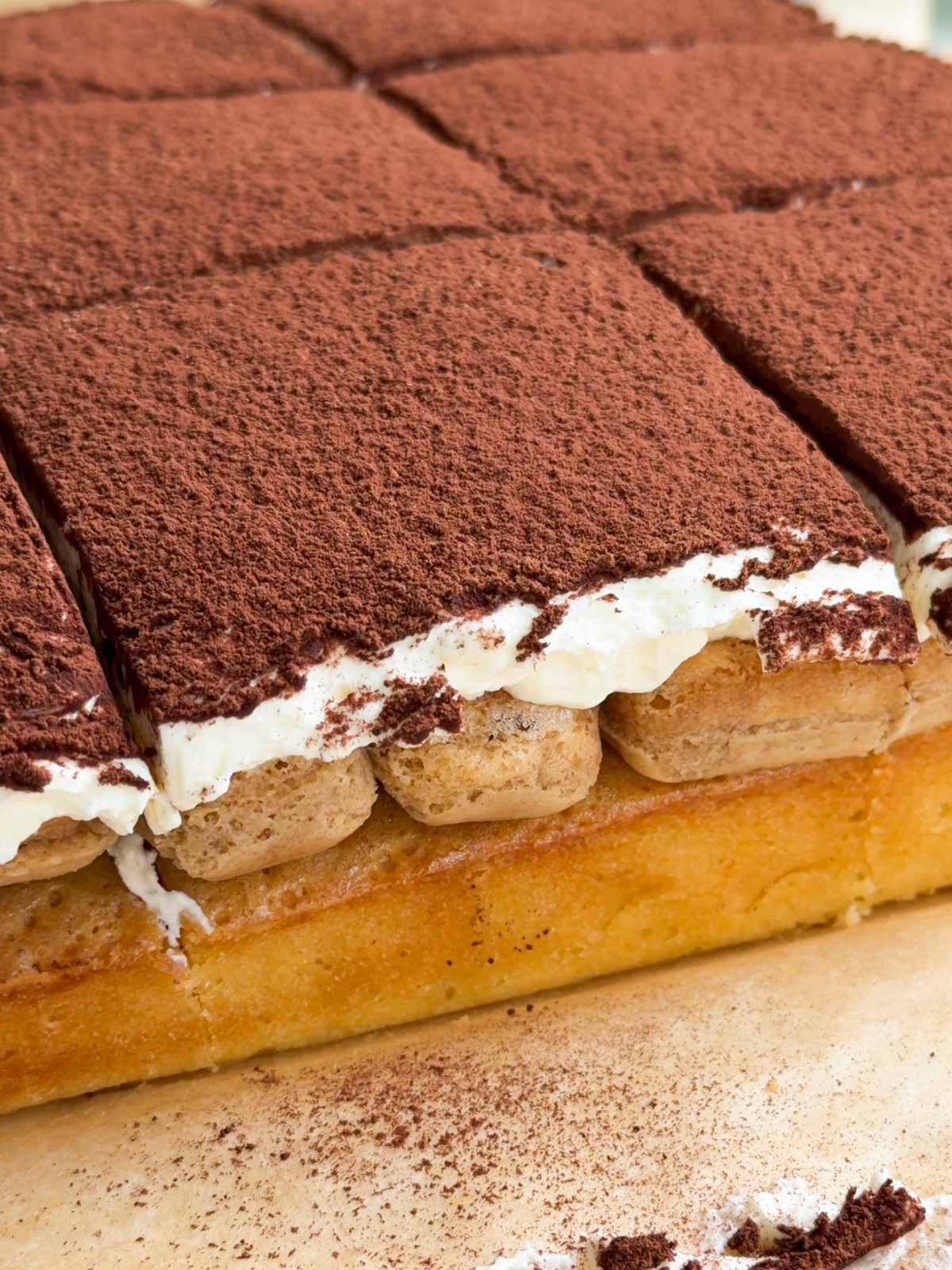 Tiramisu blondie on brown parchment paper.