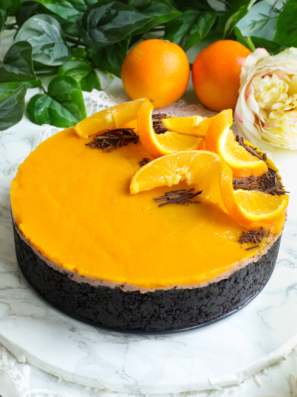 Choclate and oranges cheesecake on a table.