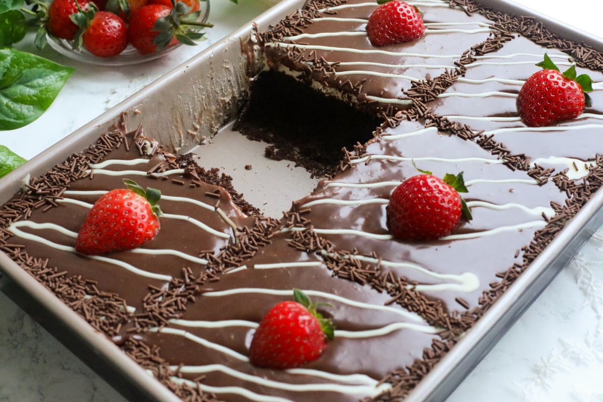 Chocolate cake with milk chocolate ganache and strawberries on top.