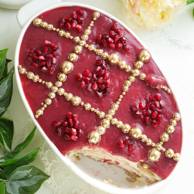 Pomegranate Tiramisu in a white oval dish.
