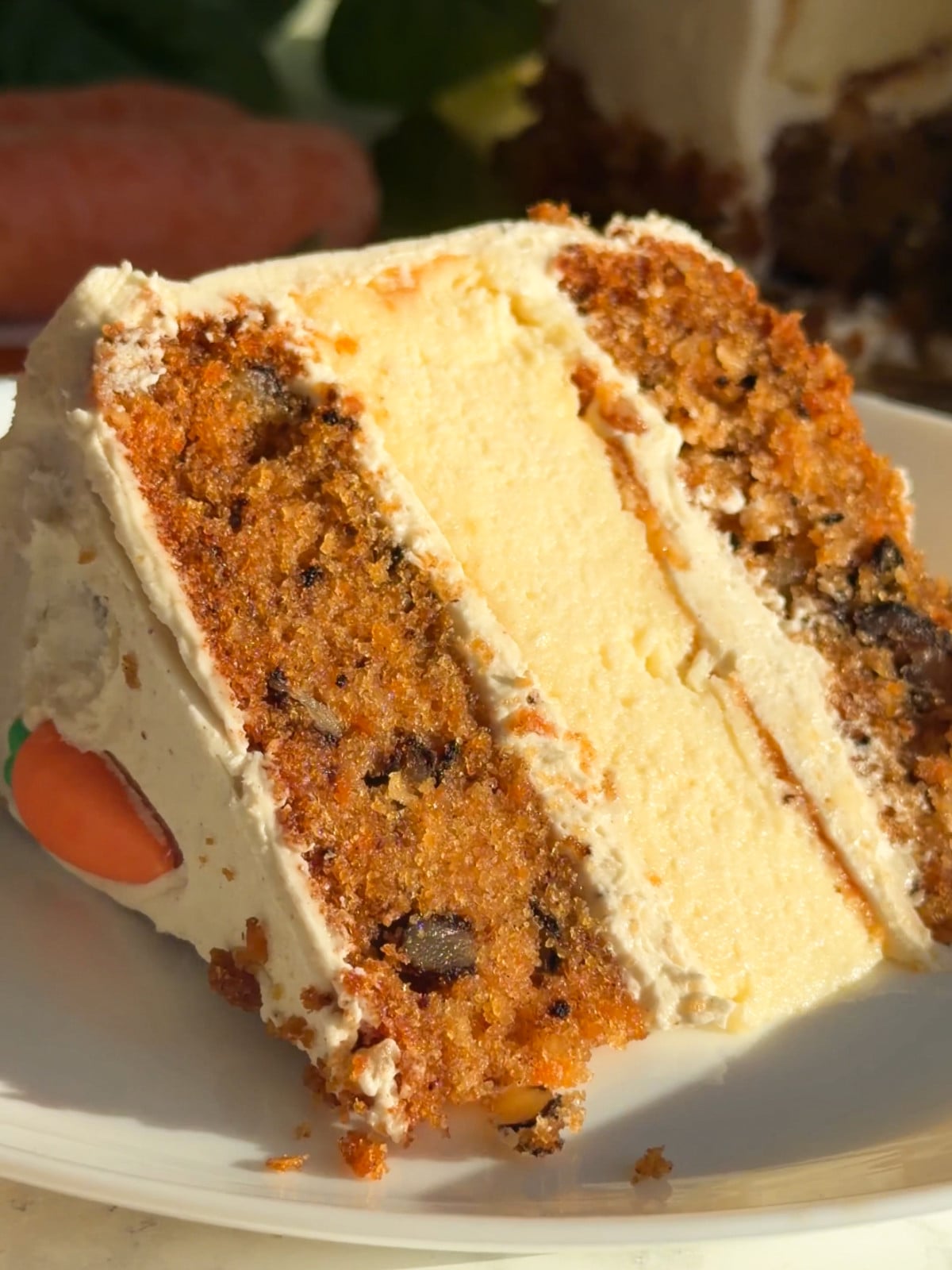 A slice of carrot cheese cake cake on a plate.